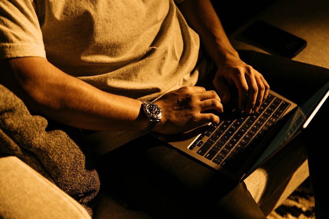 writer typing on laptop at night